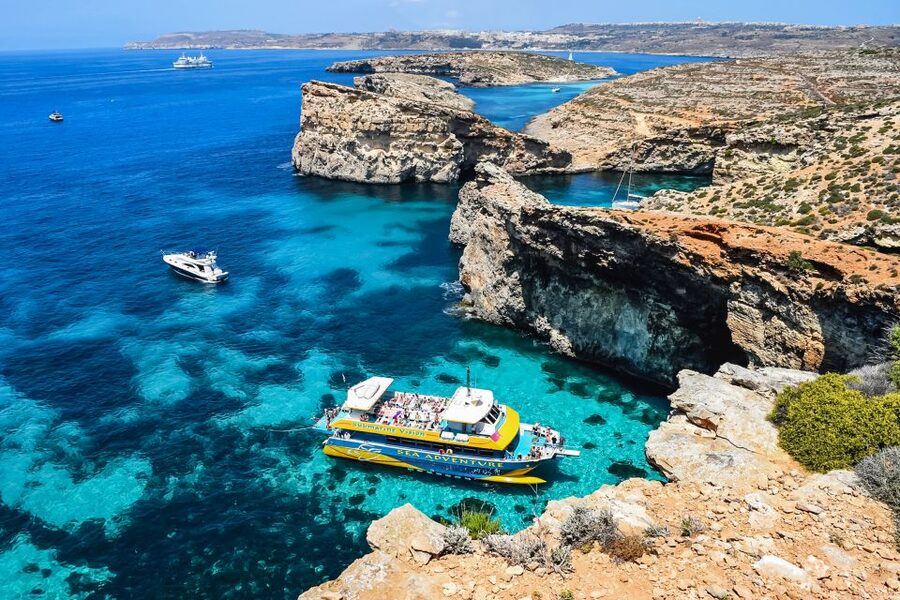 From Bugibba: Blue Lagoon Afternoon Swim with Sunset Cruise - Blue Lagoon time: beautiful water, popular setting