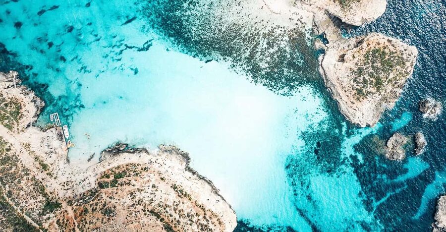 From Mellieha: Three Bay Cruise including the Blue Lagoon - The Blue Lagoon: famous water, crowded shore
