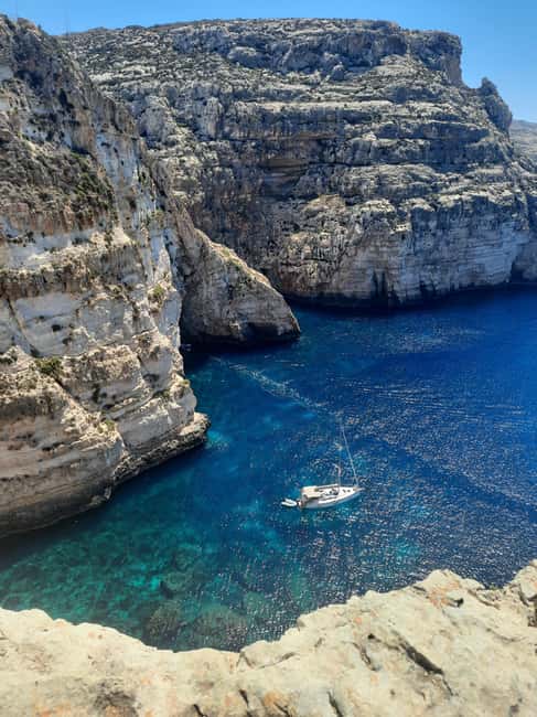 From Sliema: Blue Grotto Trip - Including Boat Cave Tour - A small boat through the Blue Grotto caves
