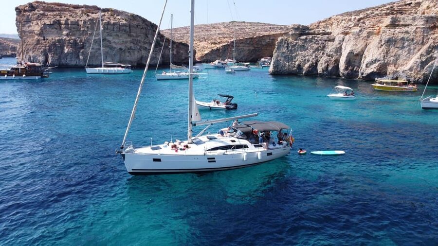 From Valletta: Romantic Sunset Cruise on a Sailing Yacht - Swimming at anchor, with a towel close by