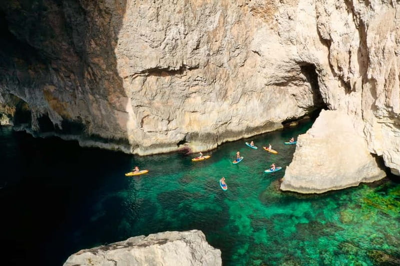 Malta: Blue Grotto SUP and Snorkeling Tour - Paddling Blue Grotto Bay 2 before the boats