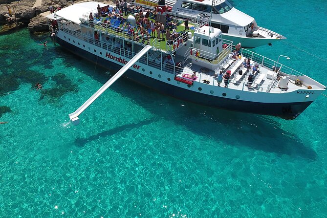 Malta Sunset Boat Tour: Bugibba to Comino Blue Lagoon Cruise - The 10-meter slide and swimming setup